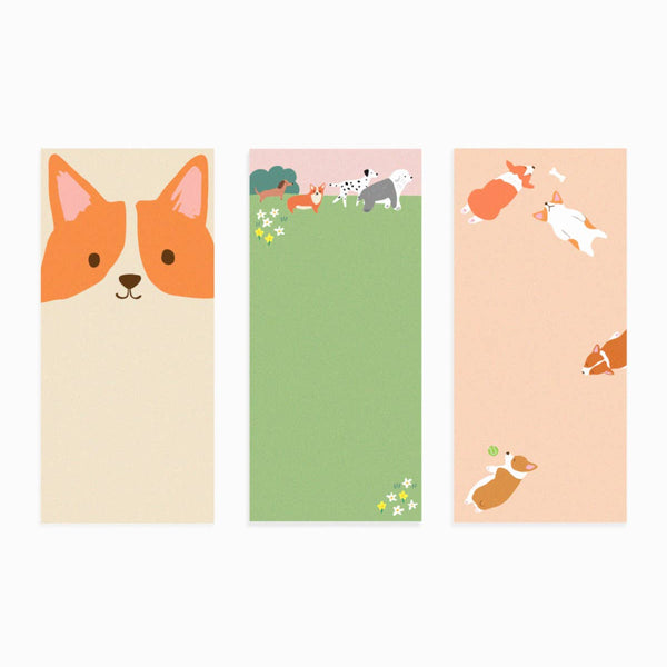Three colorful notepads with dog illustrations on a white background