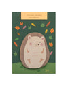 Hedgehog-themed sticky notes with branding showing colorful leaves on a green background, set against a white surface.