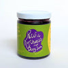 Jar of Pacific Northwest Berry Jam with a green label and white lid on a white background