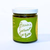 Jar of pistachio cardamom nut butter with a green label on a white background