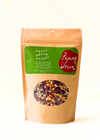 Kraft paper bag with a green label and window displaying mixed popcorn kernels, on a white background.