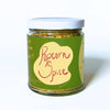 Jar of popcorn spice with a green label on a white background
