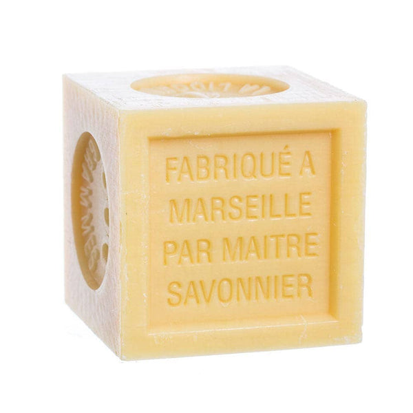 Cube-shaped honey soap with 'Fabrique a Marseille par Maitre Savonnier' text on a white background