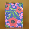 Spiral top notebook with floral design on a brown background