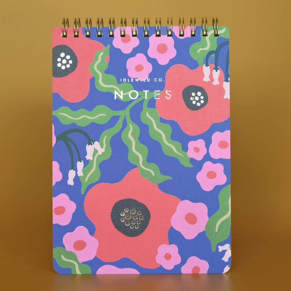 Spiral top notebook with floral design on a brown background