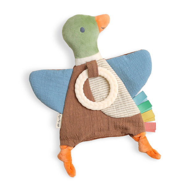 A mallard duck-shaped fabric baby toy with a green head, blue wings, brown body, orange beak and feet, a cream silicone teether ring, and multicolor ribbon sensory tabs, shown on a white background.