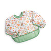 A water-resistant long sleeve baby bib in white with a colorful woodland animals print and a green crumb catching pocket hem against a white background.