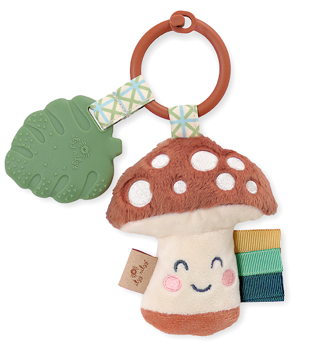 Mushroom-shaped plush toy with a teether and rattle on a white background