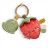 Strawberry-themed teething toy with soft texture and colorful elements on a white background