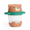 A cute bear-shaped baby snack cup  with a brown bear head lid, green handle, and a clear plastic cup body, shown on a white background.