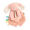 Pink plush bunny toy with a heart and colorful tags on a white background