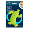 Green and blue pickle shaped silicone teether toy with grip handles on dark blue packaging against a white background.