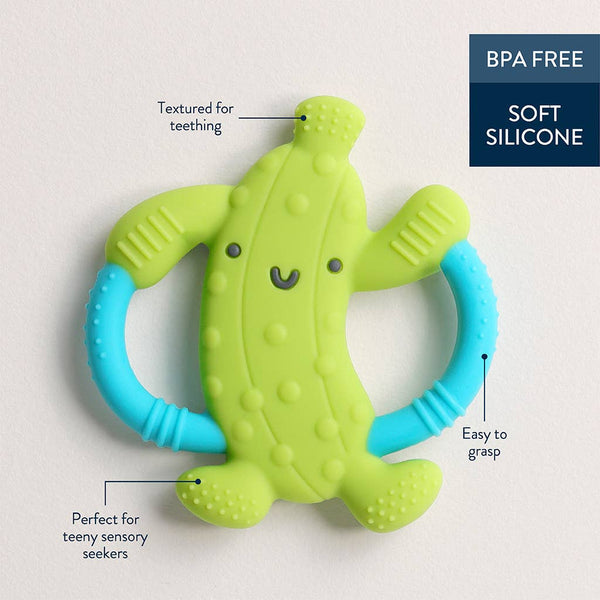 Green and blue pickle shaped silicone teething toy with text highlighting features on a light gray background