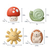 Four small bath toys with measurements on a white background