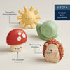 Set of four sensory bath squirters shaped like a sun, mushroom, snail, and hedgehog on a light background.