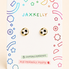 A pair of soccer-ball stud earrings displayed on a white JAXKELLY brand backing card. The backing card features colorful geometric doodles and text highlighting features like 'Hypoallergenic' and 'Kid-Friendly Posts'.