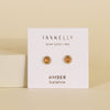 Jaxkelly amber and gold stud earrings on a branded card with a beige background