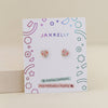 Jaxkelly bow-shaped enamel kid's earrings on a branded card with geometric design