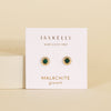 Gold stud earrings with green malachite stones on a Jaxkelly branded card against a beige background