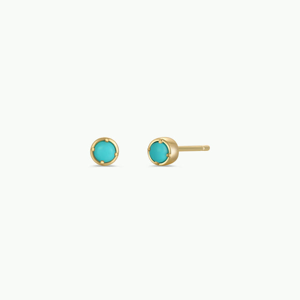 Gold earrings with turquoise stones on a white background