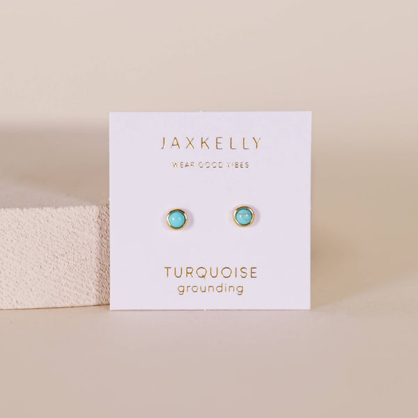 Turquoise earrings on a Jaxkelly branded card with a beige background