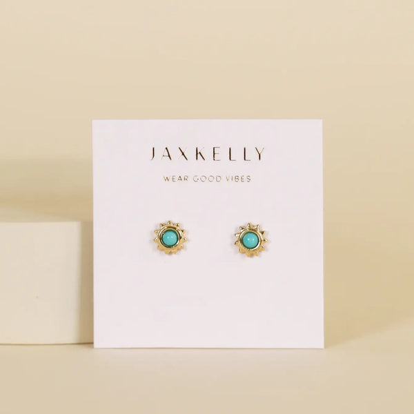 Jaxkelly gold and turquoise stud earrings on a display card with a beige background