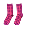 A pair of crew socks featuring a magenta and lighter hot pink grid plaid pattern, displayed against a solid white background.