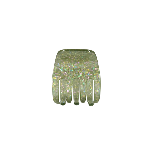 A small green translucent hair claw comb filled with iridescent glitter, shown against a plain white background.