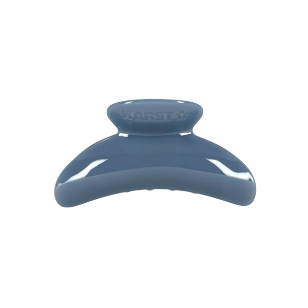 A glossy blue hair claw clip with the brand name 'KARST' embossed on the top, shown against a plain white background.