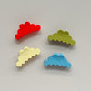 Four cloud-shaped hair claw clips in red, pear green, pale yellow, and light blue, arranged on a light gray background. Each clip has the brand name 'Kaxi'.