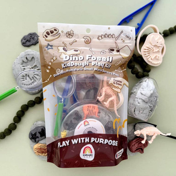 Dino Fossil KidDough Play Kit packaging with play materials on a light green background