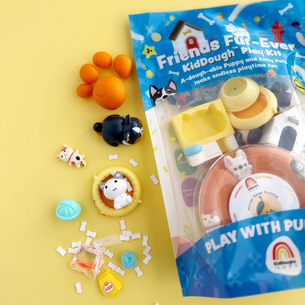 Packaged modeling clay toy set with colorful dough balls and animal figurines on a yellow background