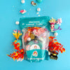 Mermaid-themed kid dough play kit with ocean-themed decorations on a blue background