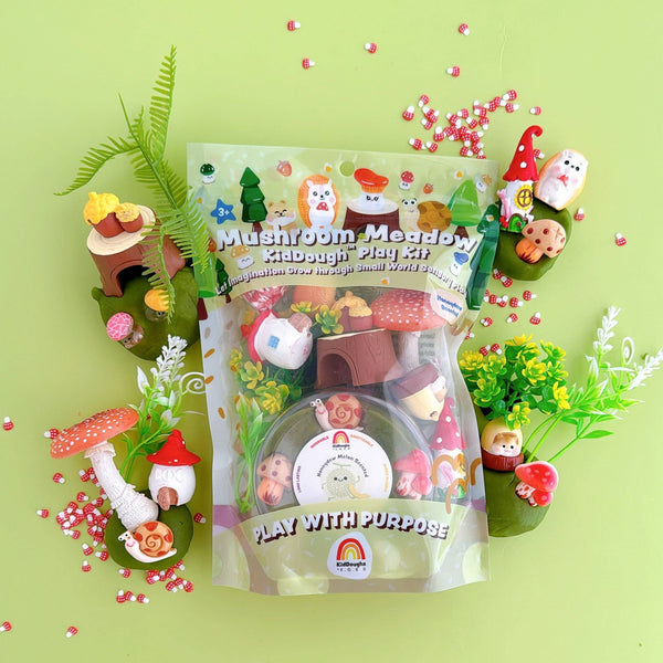 Mushroom Meadow play kit packaging on a green background with small garden figurines.