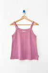 Pink tank top on a wooden hanger against a white background