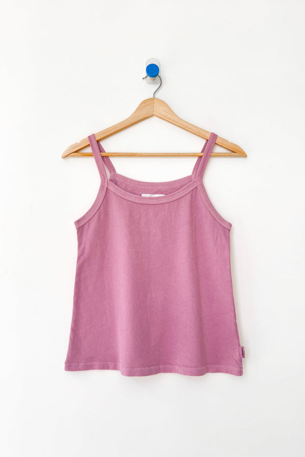 Pink tank top on a wooden hanger against a white background