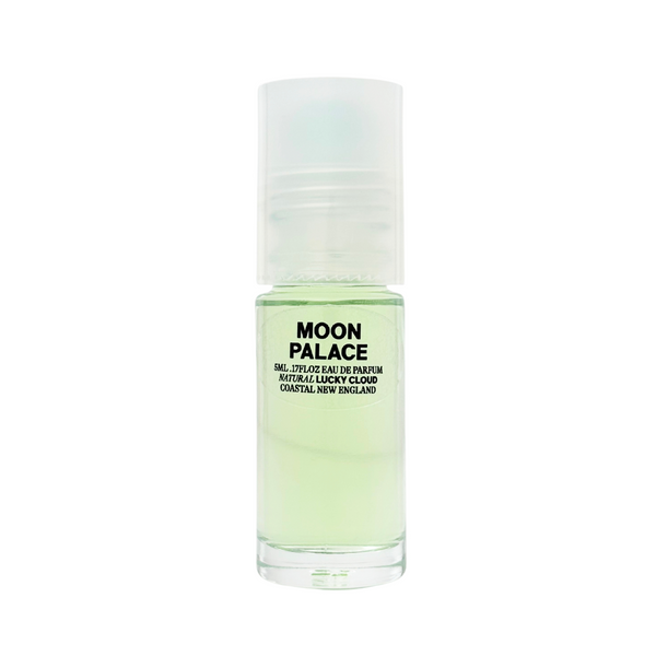 A small clear roll-on bottle of natural pale green perfume by Lucky Cloud called 'Moon Palace' against a white background.