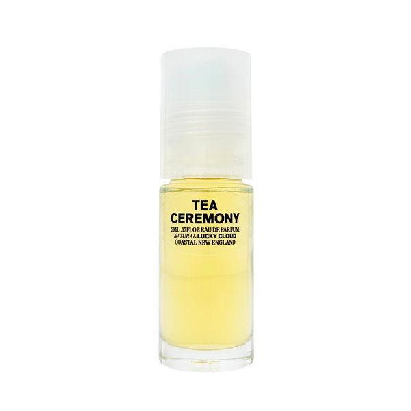 A small roll-on bottle of pale yellow natural perfume by Lucky Cloud called 'Tea Ceremony' against a white background.