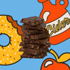 A stack of five broken chocolate bars with visible crumb texture, centered on a bright blue background with stylized illustrated donut, apple, and cider bottle graphics.