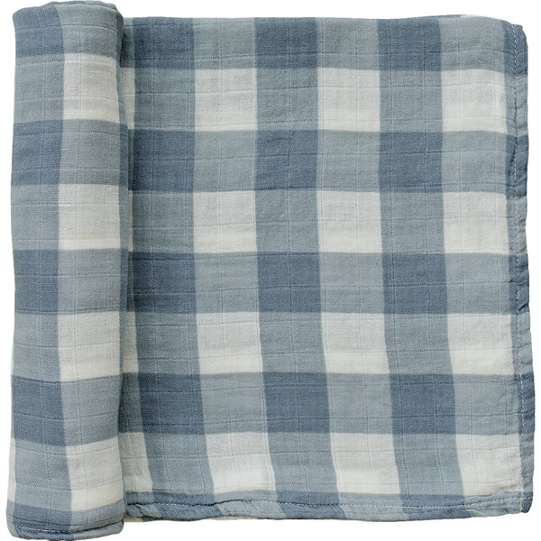 A partially unrolled muslin swaddle blanket in a tonal dusty blue large gingham print on a white backdrop. 