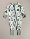 A baby zip-front romper in white with farm motifs and light green trim & cuffs against a neutral backdrop.
