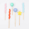 Colorful balloon shaped birthday cake candles with various shapes on a white background