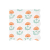 Floral patterned wavy-edged paper napkin with orange flowers and green leaves on a white background