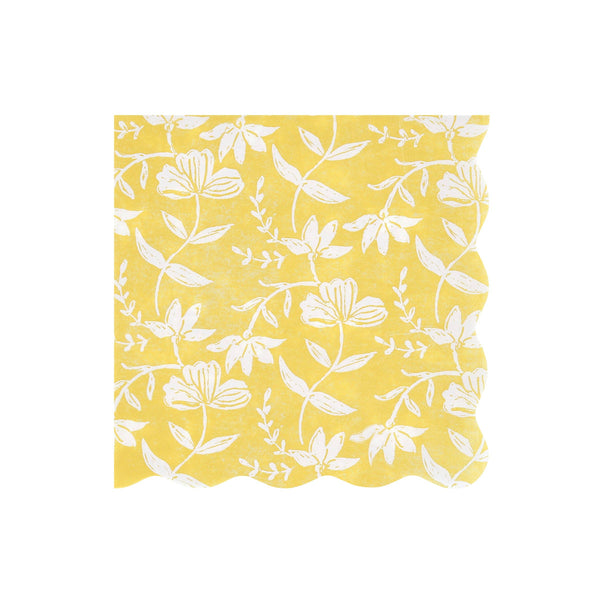 Yellow wavy-edged paper napkin with white floral pattern on a white background