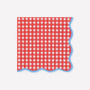 Red and white checkered napkin with blue wavy edged border on a white background