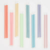 Set of long colorful striped candles on a white background
