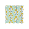 Wavy-edged paper napkin with yellow floral pattern on a light blue background