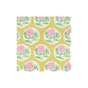 Patterned wavy-edged paper napkin with pink flowers and green leaves on a yellow background