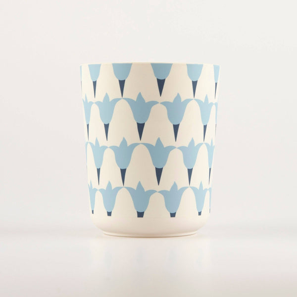 Melamine and cellulose reusable tumbler cup with blue and white geometric floral pattern on a light gray background