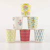 Set of six colorful patterned cups stacked on a white background
